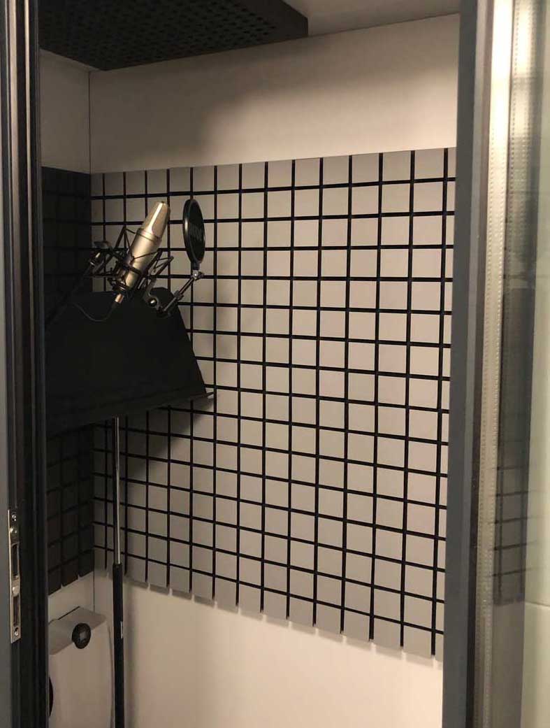 A sound-proof booth in an audio recording studio.