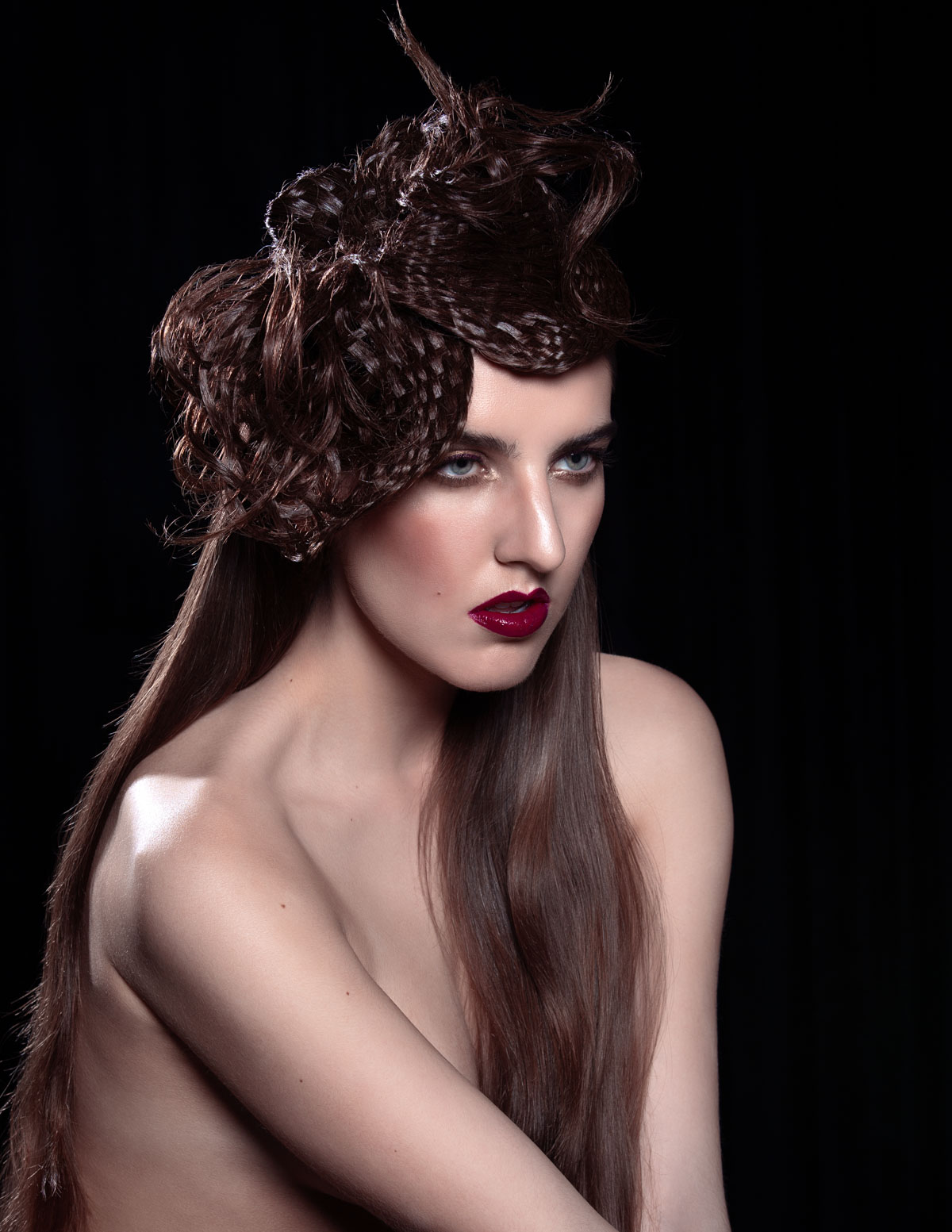 A model with an extravagant hair style and bright red lipstick
