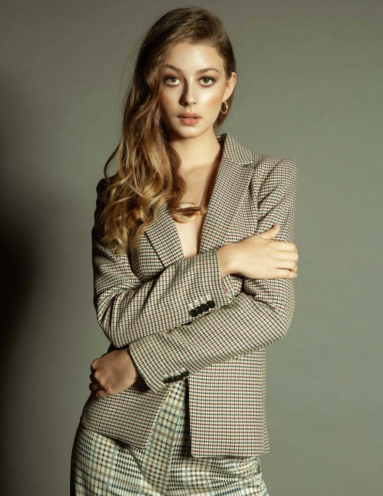 A fashion model posing in plaid jacket and pants